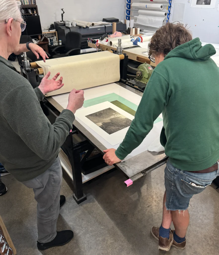 Serene sunset over an open field with wildflowers, capturing the peaceful atmosphere of a four-day photogravure workshop.