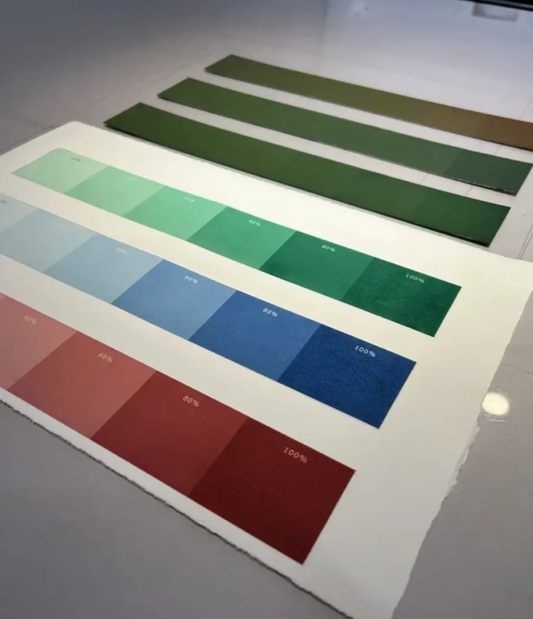 Etching ink drawdown prints in red, blue and green, each showing six coverage steps