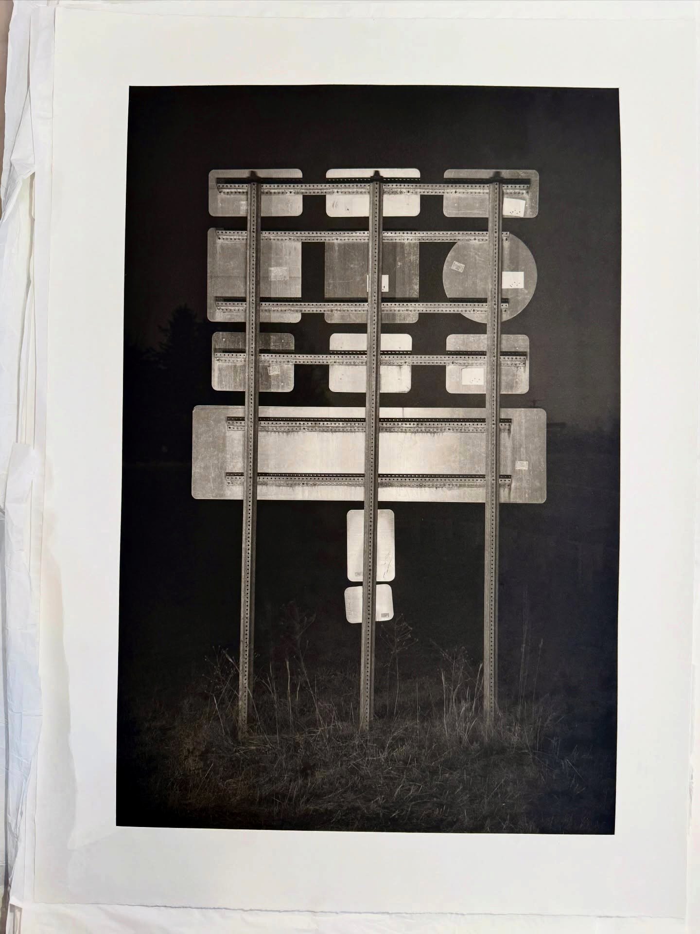 Photogravure print by Nick Ruth of a roadside sign at night, printed during a residency week at the studio
