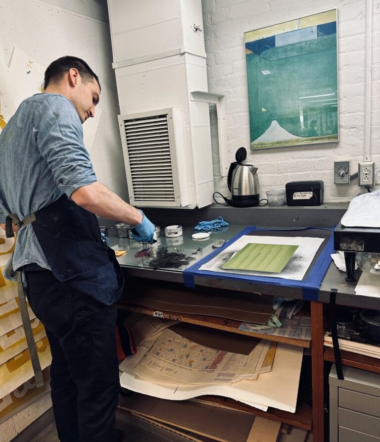 Printmaker inking a photopolymer gravure plate at the inking station at Prints on Paper Studio